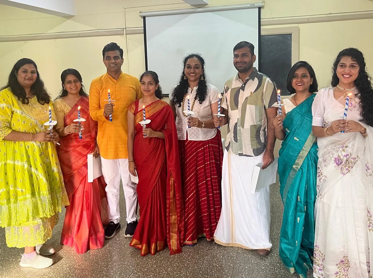 Niharika with her training cohort, each holding a lit candle